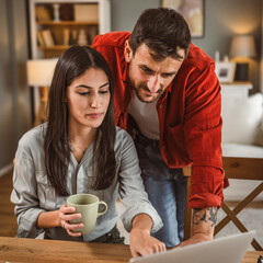 Woman work from home on laptop while boyfriend help and support her