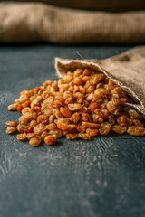 Raisins spill out of a burlap bag