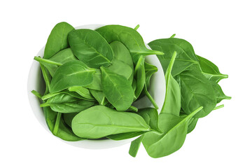 Baby spinach leaves in ceramic bowl isolated on white background. Top view. Flat lay