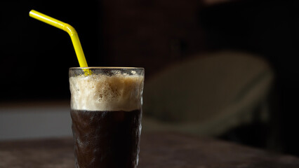 close up view of homemade iced coffee with straw
