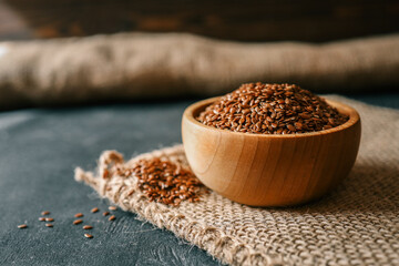 Flax seed in a wooden bowl. Close-up