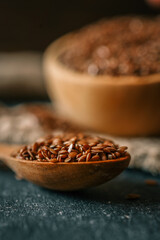 Flax seed in a wooden bowl. Close-up