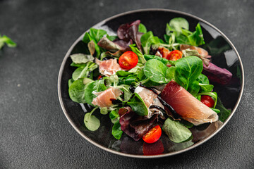 salad jamon, green leaf lettuce, tomato, salad dressing fresh meal food snack on the table copy space food background rustic top view 