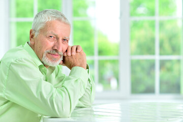 close-up portrait of a senior man thinking about something