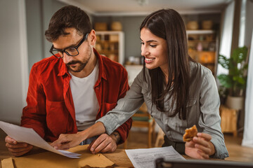 Couple prepare documents for work have coffee and breakfast at home