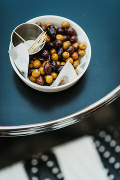 bowl with black and green olives on a bistro table in Paris