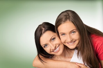 Beautiful young female hugging her mother