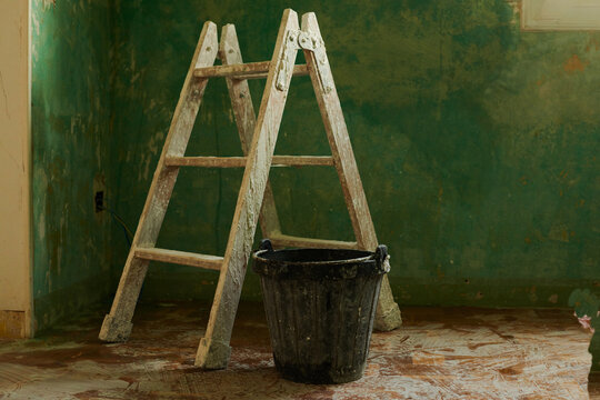 Painter ladder and bucket at renovation work of an apartment
