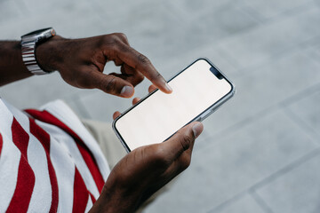 A phone with a white screen in a man's hand