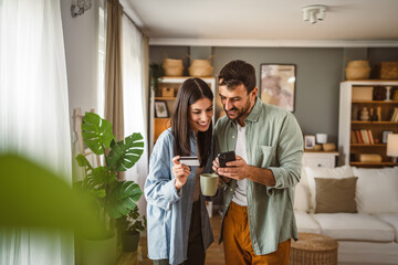 Couple and buy online on mobile phone with credit card at home