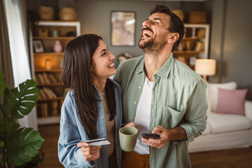 Couple and buy online on mobile phone with credit card at home