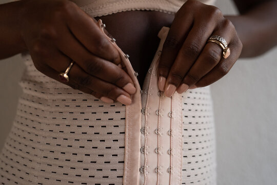 Black woman wearing belly shaper belt