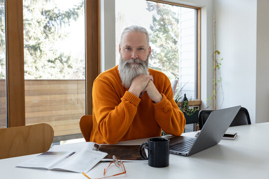 Looking At Camera Behind Laptop