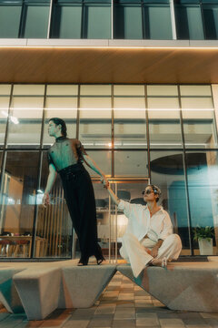 Leaning duo in futuristic fashion