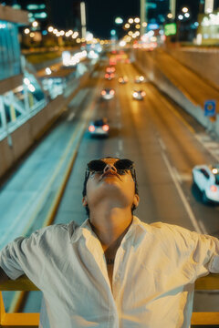Woman carefree leaning agains a bridge