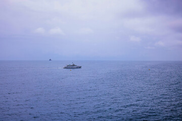 Boat in View on Miramare castle on the gulf of Trieste on northeastern Italy. Long exposure image technic with reflection on the water