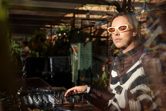 DJ enjoying the vibe of music and wearing stylish look in summertime