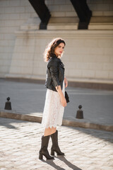 attractive woman walking in street in fashionable outfit