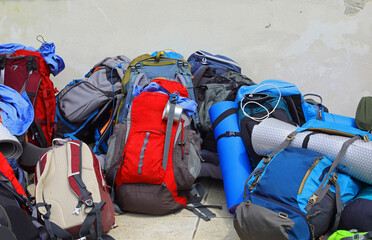 backpacks and sleeping bags and mats of the young adventurous backpackers during the summer camp