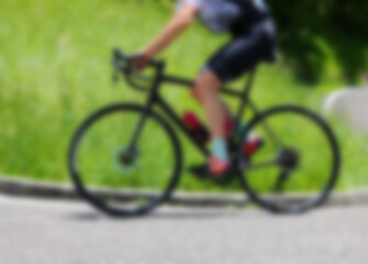 Fototapeta premium Blurred racing bike with cyclist as background for sporting and competition concepts