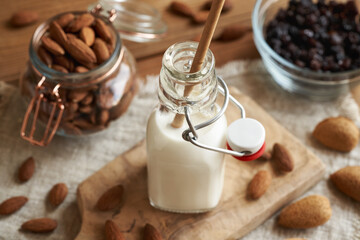 A bottle of vegan almond milk with an ecological paper straw. Zero waste.