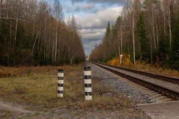 The railway track stretches into the distance towards the horizon, autumn time