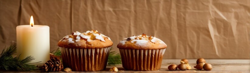 A candle and a vanilla muffin next to a fir twig. A festive banner.