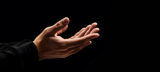 Praying Hands with White Embroidered Robe Against Dark Background