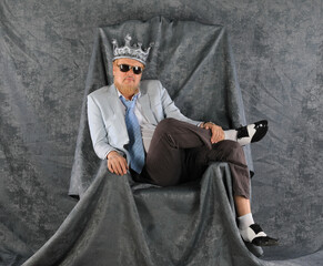 big boss with a crown, successful businessman in a suit sit in the throne