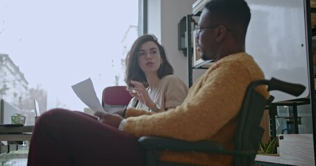 A multicultural group of business workers collaborate, discussing strategies and analyzing statistical data for corporate growth. - Powered by Adobe