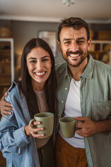 Portrait of boyfriend and girlfriend drink coffee and enjoy at home