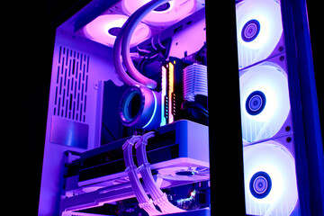 Gaming computer with RGB light, close-up. Components of a powerful liquid-cooled gaming computer with a modern graphics card. Personal PC with white Components.