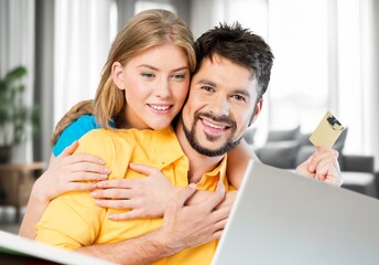 Fototapeta premium Cheerful young lovely couple use laptop