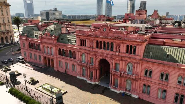 Facade of the government house Casa Rosada. Front aerial camera rises and tilts downward
