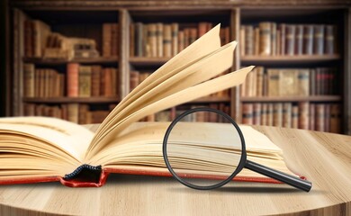 magnifying glass on the page of book, education concept