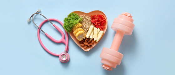 Plate with fresh healthy products, stethoscope and dumbbell on blue background. Diet concept