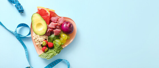 Plate with fresh healthy products and measuring tape on blue background. Diet concept
