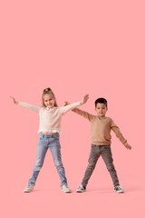 Obraz premium Cute little children in sweaters on pink background