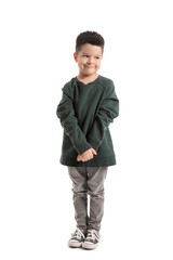Naklejka premium Cute little boy in knitted sweater on white background