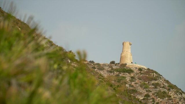 Slow motion, beautiful landscape with a historic watchtower on background, in Torre del Gerro, D&eacute;nia (Alicante ,Spain)