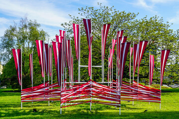 Many national flags of Latvia flutter in the wind, decoration of the city square in holidays