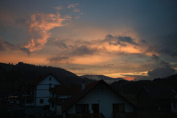 View of village in Carpathian mountains at sunset