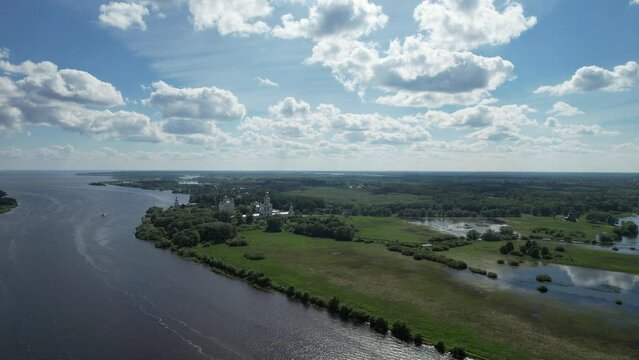 Panoramic aerial view of the Volkhov River and Lake Ilmen near Veliky Novgorod, natural attractions of Russia. Orthodox monastery on the river bank