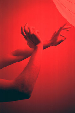 Crop hands in neon light