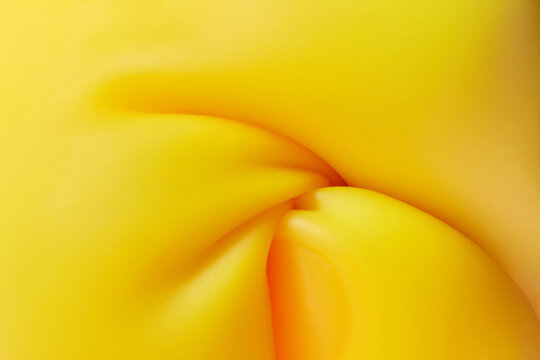 Curling and flowing curvy shapes of yellow plasticine waves