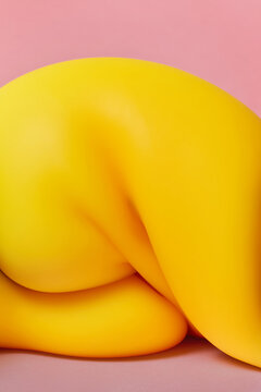 Yellow squish toy formed into abstract figure with deep wrinkles