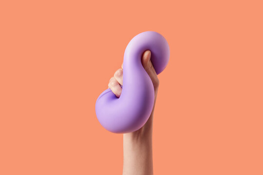 Human hand queezing purple elastic material and feeling softness