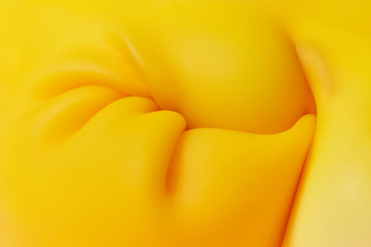 Yellow substance shrinking under pressure and creating folds