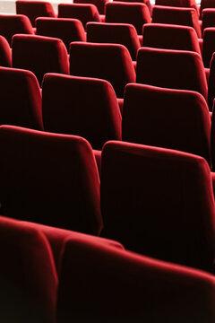 Rows of red seats in a theater hall