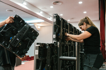 Professional woman connecting wires of LED panels